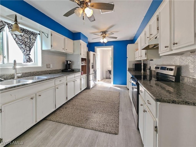 kitchen featuring stainless steel appliances, white cabinetry, sink, and light hardwood / wood-style flooring