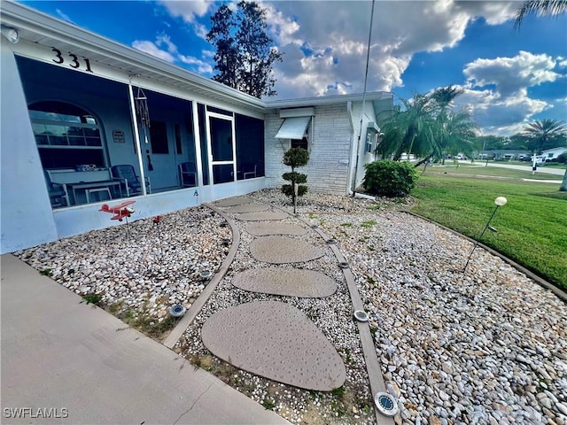 view of patio / terrace featuring a sunroom