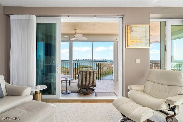 interior space featuring a water view and ceiling fan