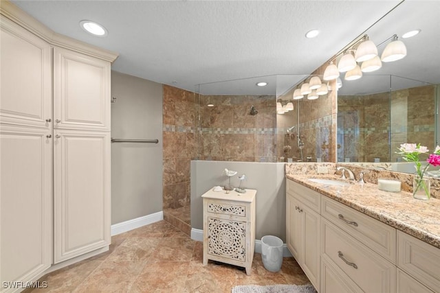 bathroom with vanity and tiled shower