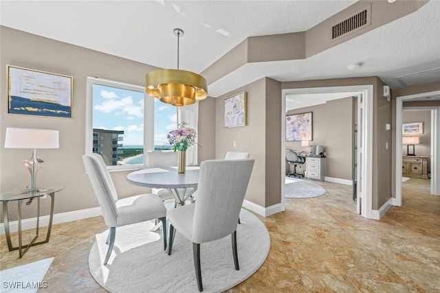 dining space with a textured ceiling