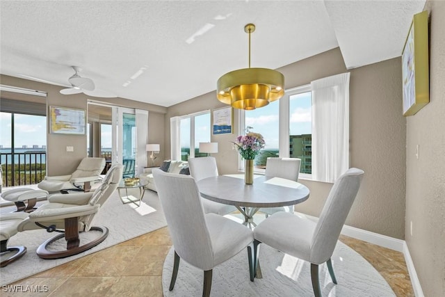 dining space featuring a textured ceiling and a wealth of natural light