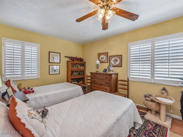 tiled bedroom with ceiling fan