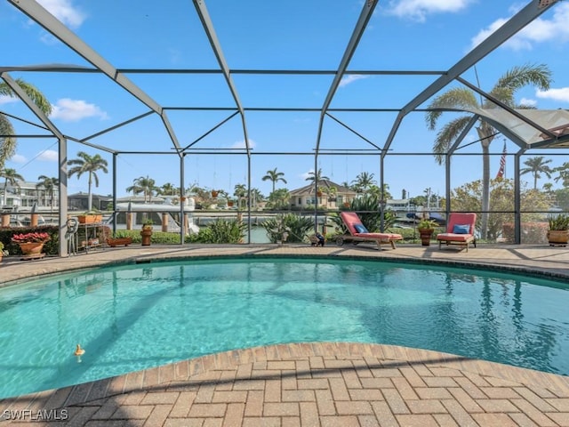 view of swimming pool with a lanai and a patio