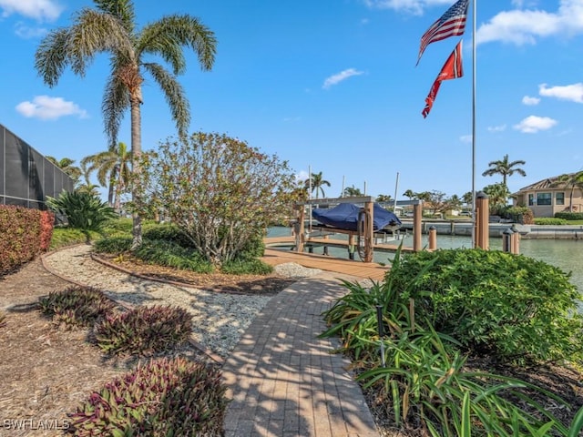 view of property's community featuring a boat dock and a water view