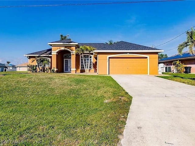 view of front of home with a garage and a front lawn