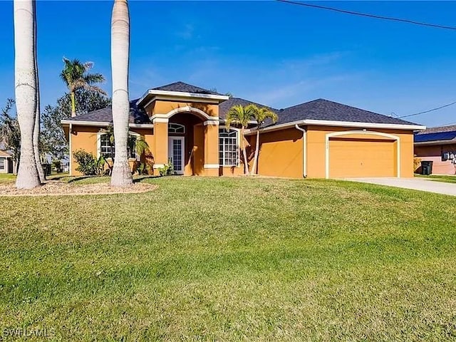 view of front of property with a garage and a front lawn