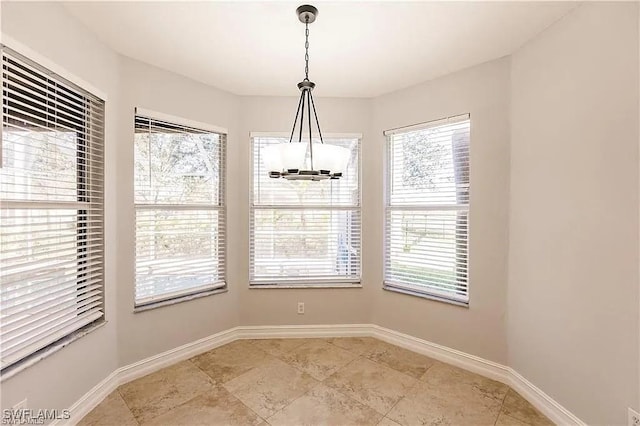 unfurnished dining area featuring a notable chandelier