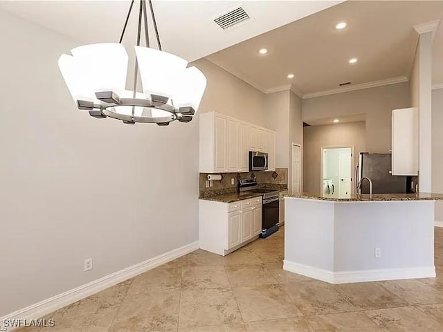 kitchen with white cabinetry, hanging light fixtures, dark stone counters, kitchen peninsula, and stainless steel appliances