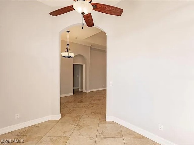 spare room featuring light tile patterned floors and ceiling fan