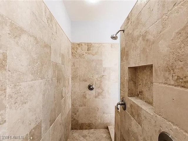 bathroom with a tile shower