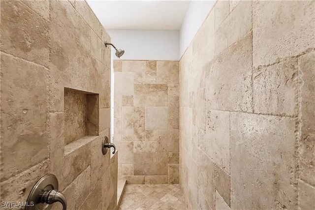 bathroom with tiled shower