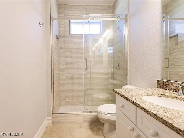 bathroom with vanity, toilet, and a shower with shower door