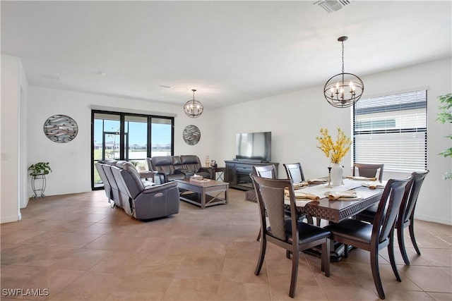 dining area with a notable chandelier and light tile patterned flooring