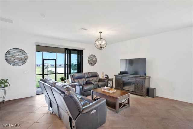 living room with an inviting chandelier and light tile patterned floors