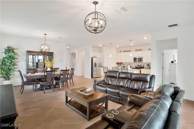 living room featuring light tile patterned floors and an inviting chandelier