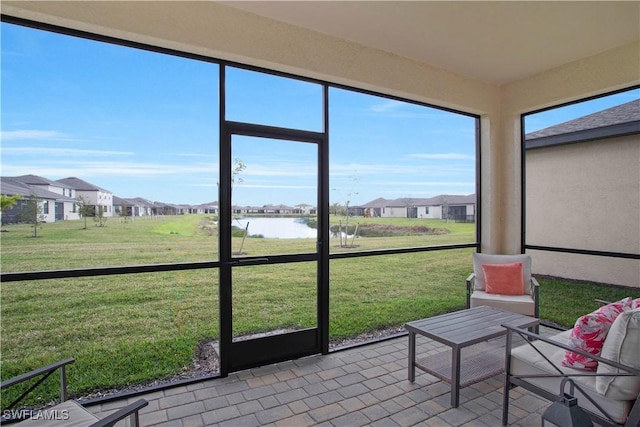 unfurnished sunroom with a water view