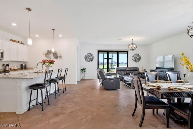 dining area with an inviting chandelier and sink