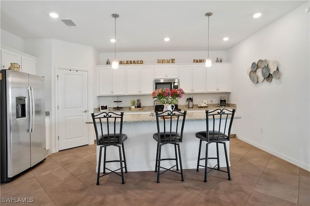 kitchen with a kitchen island with sink, hanging light fixtures, white cabinetry, and stainless steel appliances