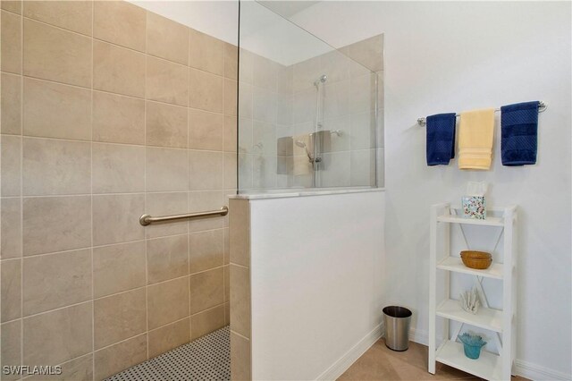 bathroom with a tile shower