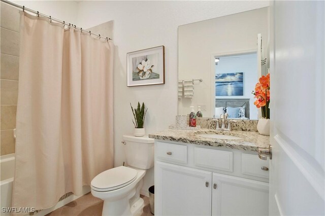 full bathroom featuring vanity, shower / tub combo, and toilet