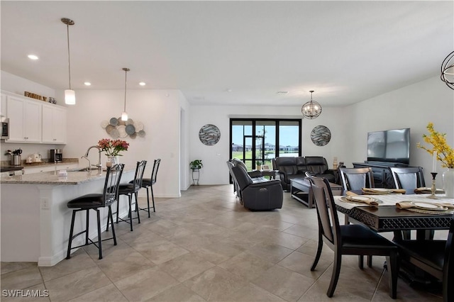 dining room with a notable chandelier and sink