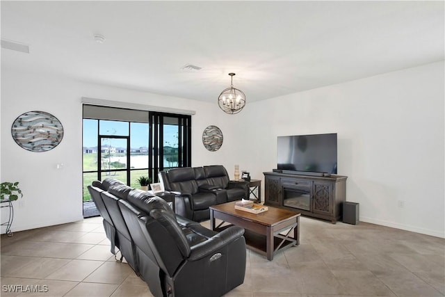 tiled living room featuring a notable chandelier