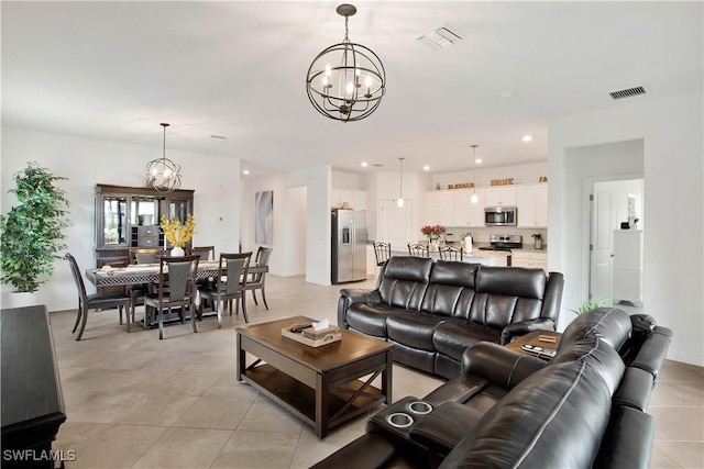 tiled living room featuring an inviting chandelier