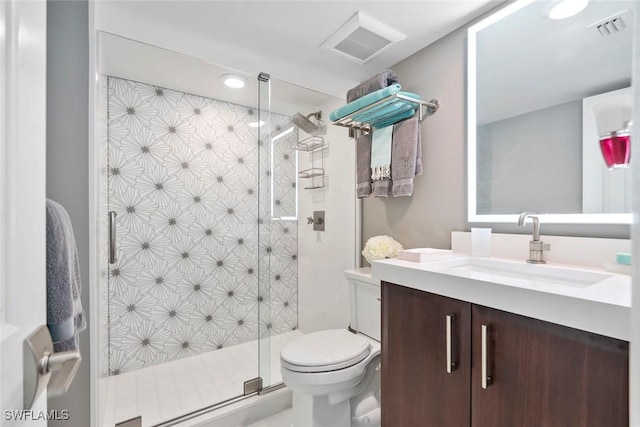 bathroom with vanity, an enclosed shower, and toilet