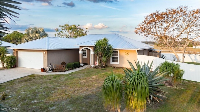 ranch-style house with a garage and a front lawn