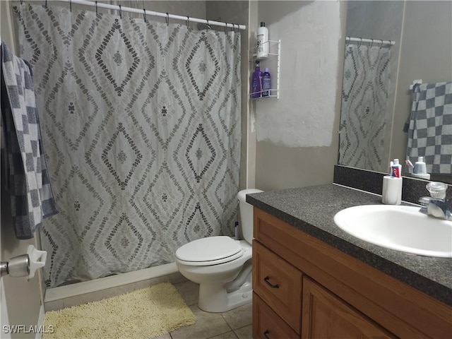 bathroom featuring tile patterned flooring, vanity, a shower with shower curtain, and toilet