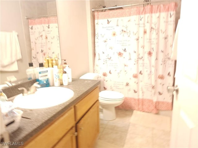 bathroom featuring vanity, tile patterned flooring, and toilet