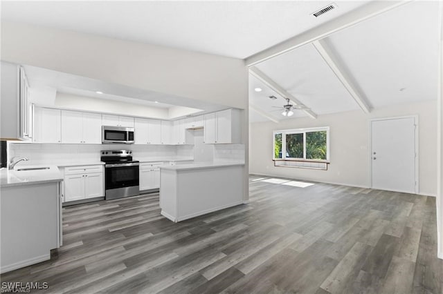 kitchen with sink, white cabinetry, vaulted ceiling with beams, stainless steel appliances, and decorative backsplash