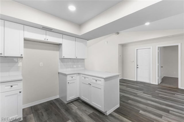 kitchen featuring white cabinets, dark hardwood / wood-style flooring, and decorative backsplash