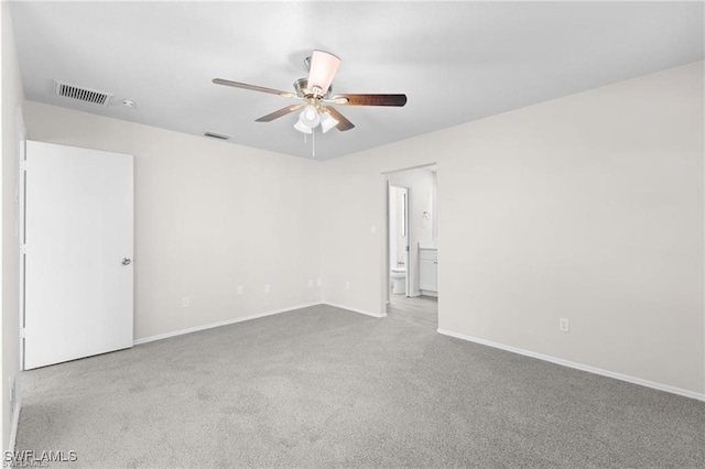 carpeted spare room featuring ceiling fan