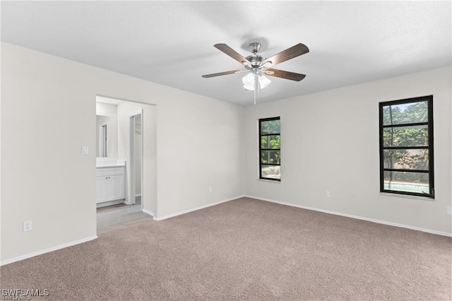 empty room featuring light carpet and ceiling fan