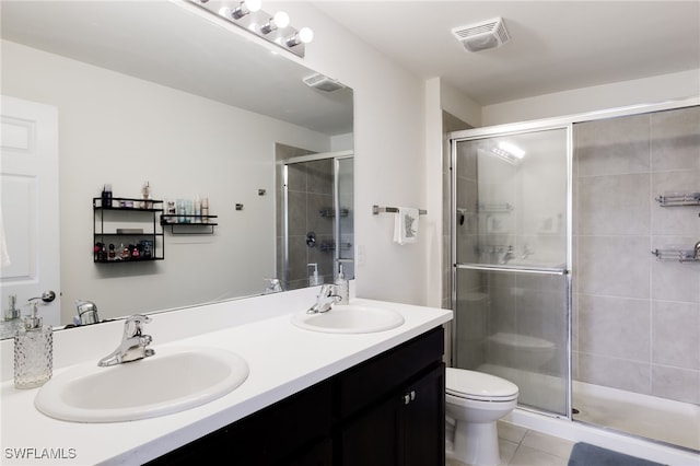 bathroom with vanity, toilet, an enclosed shower, and tile patterned flooring