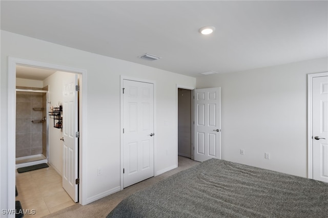 carpeted bedroom featuring ensuite bath