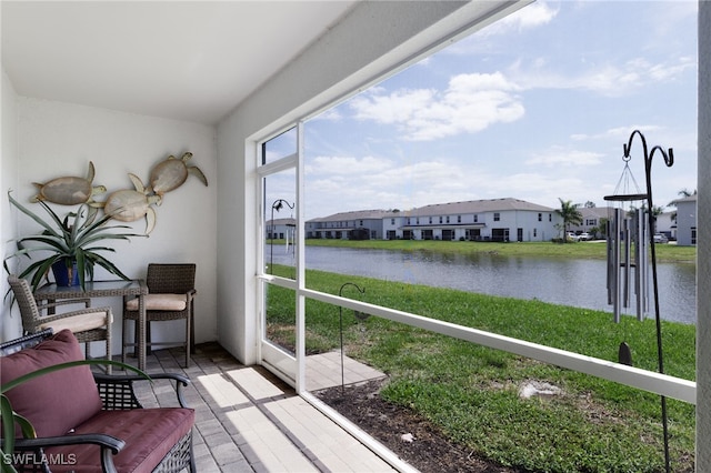 sunroom / solarium with a water view