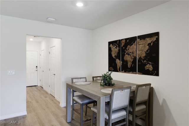 dining space with light hardwood / wood-style flooring