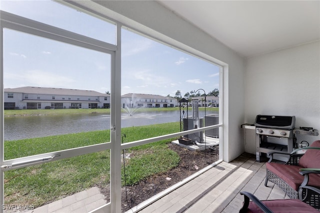 sunroom with a water view and plenty of natural light