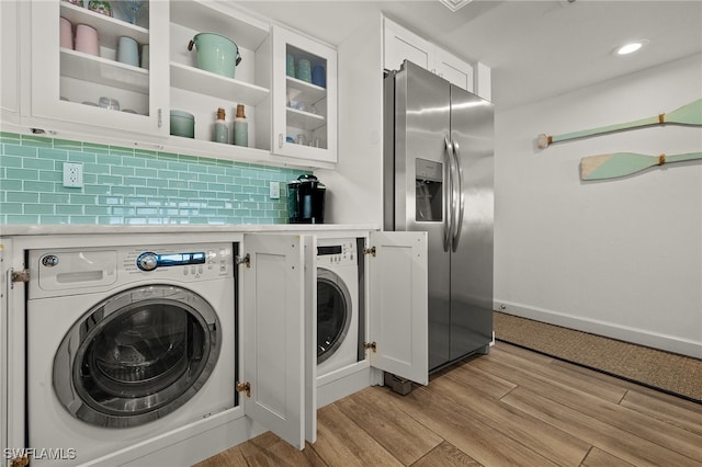 laundry area featuring washer / clothes dryer and light wood-type flooring