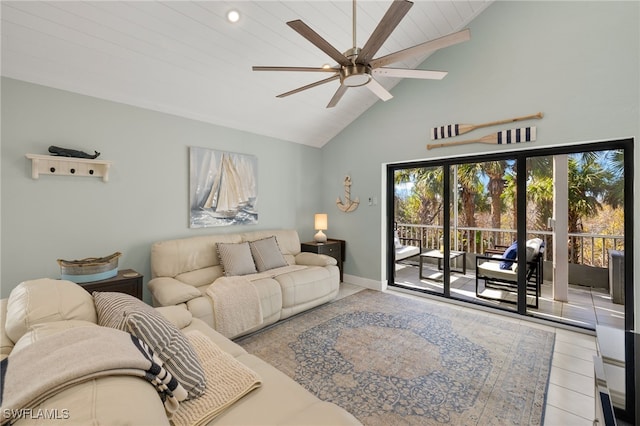 tiled living room featuring ceiling fan and high vaulted ceiling