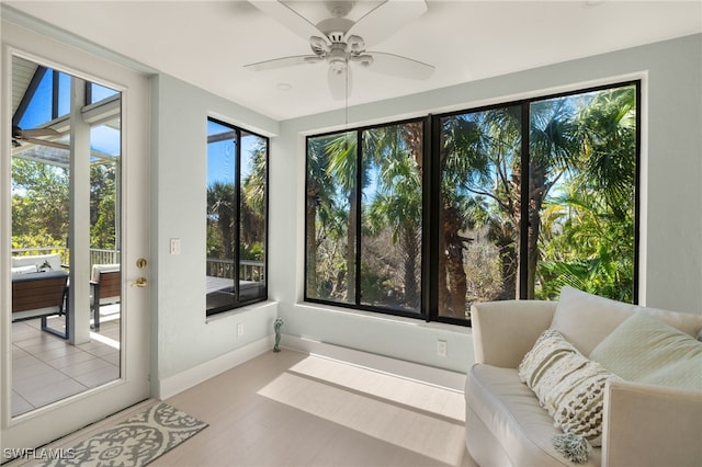 sunroom featuring ceiling fan