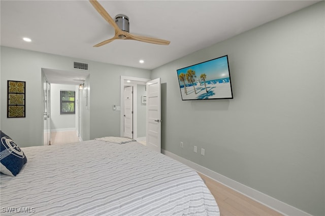 bedroom with hardwood / wood-style floors and ceiling fan