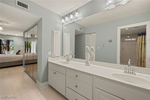 bathroom featuring hardwood / wood-style flooring and vanity