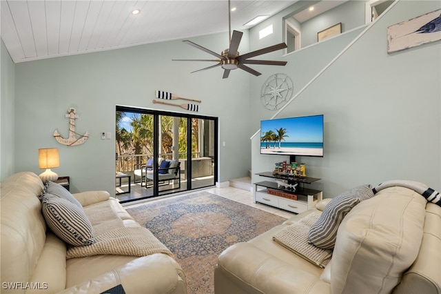 living room with ceiling fan, high vaulted ceiling, and light tile patterned floors