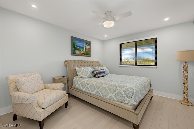 bedroom with ceiling fan and light hardwood / wood-style flooring