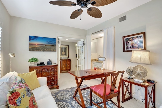 carpeted living room featuring ceiling fan