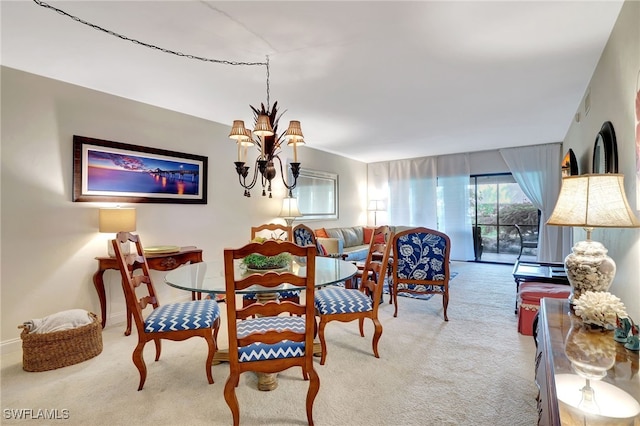 dining space featuring light colored carpet and a chandelier